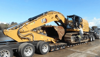 An image of transporting Caterpillar excavator from boom and bucket.