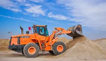 An image illustrating an excavator on a job site.